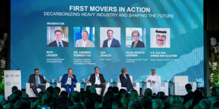 A group of people sitting on the stage of the FMC Panel Session at COP28